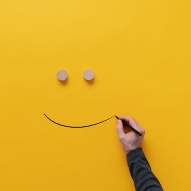 a sketch of a smile on a yellow paper