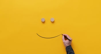 a sketch of a smile on a yellow paper