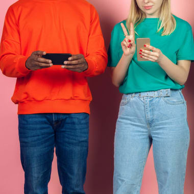 young people in colourful t-shirts using mobile phones