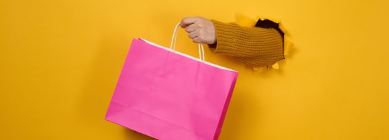 a hand keeping a pink bag