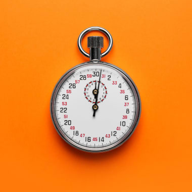 Vintage timer on orange background, top view