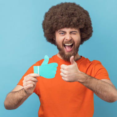 a mna holding a paper Facebook upvote icon
