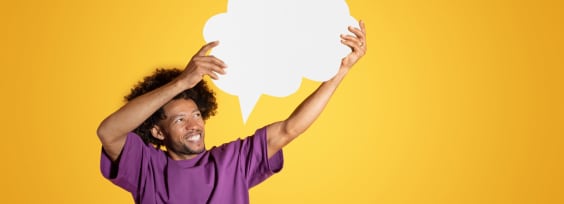a men in purple t-shirt holding the chat bubble