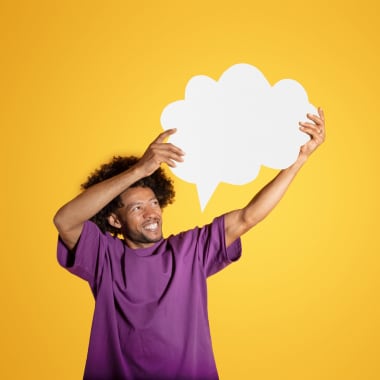 a men in purple t-shirt holding the chat bubble