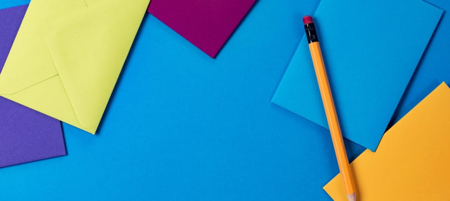 papers on blue table with pencil