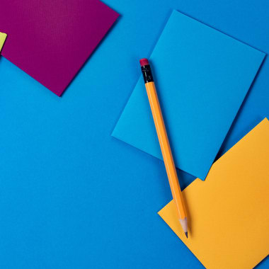 papers on blue table with pencil