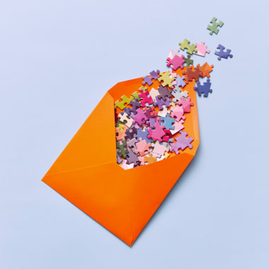 an orange envelope with colorful puzzles