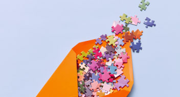 an orange envelope with colorful puzzles