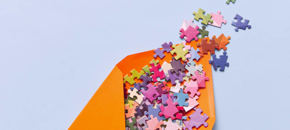 an orange envelope with colorful puzzles